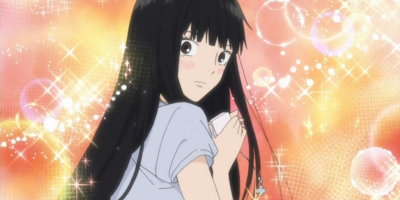 Sawako Kuronuma from Kimi ni Todoke looking over her shoulder with sparkly orange background.